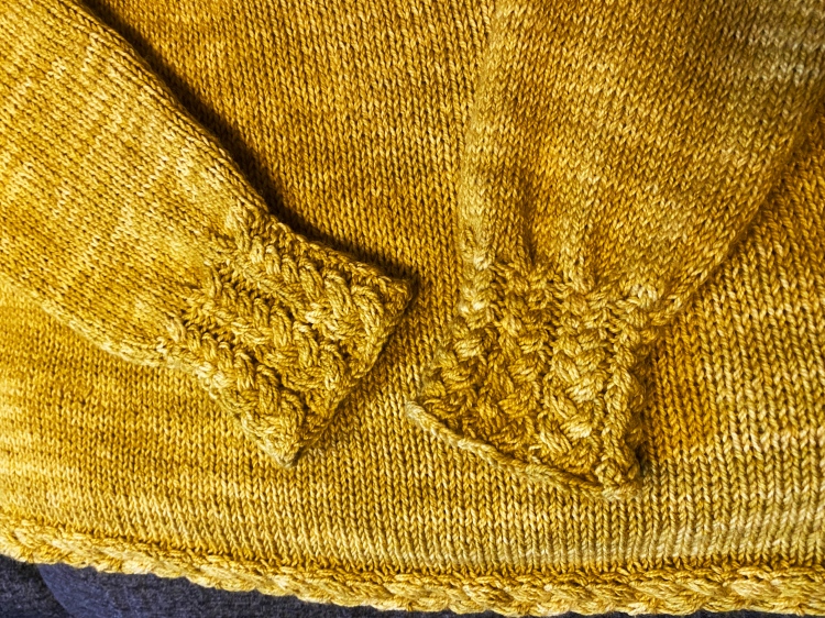 closeup of cuffs on sweater laying flat