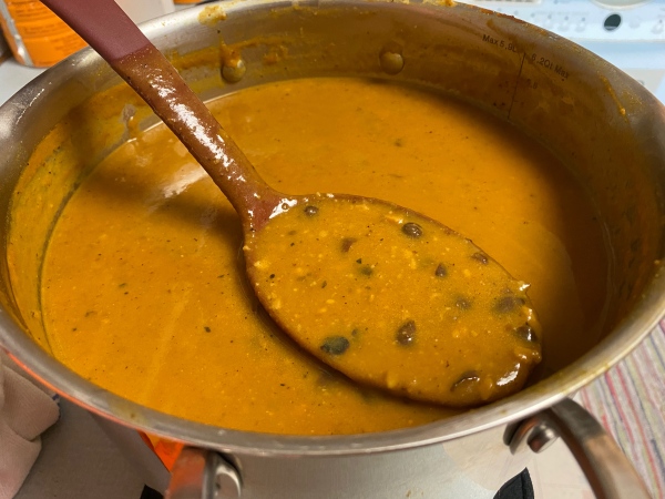 large pot full close to the top with the pumpkin black bean soup