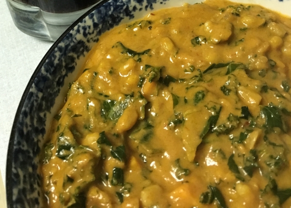 closeup of a bowl of peanut stew with kale